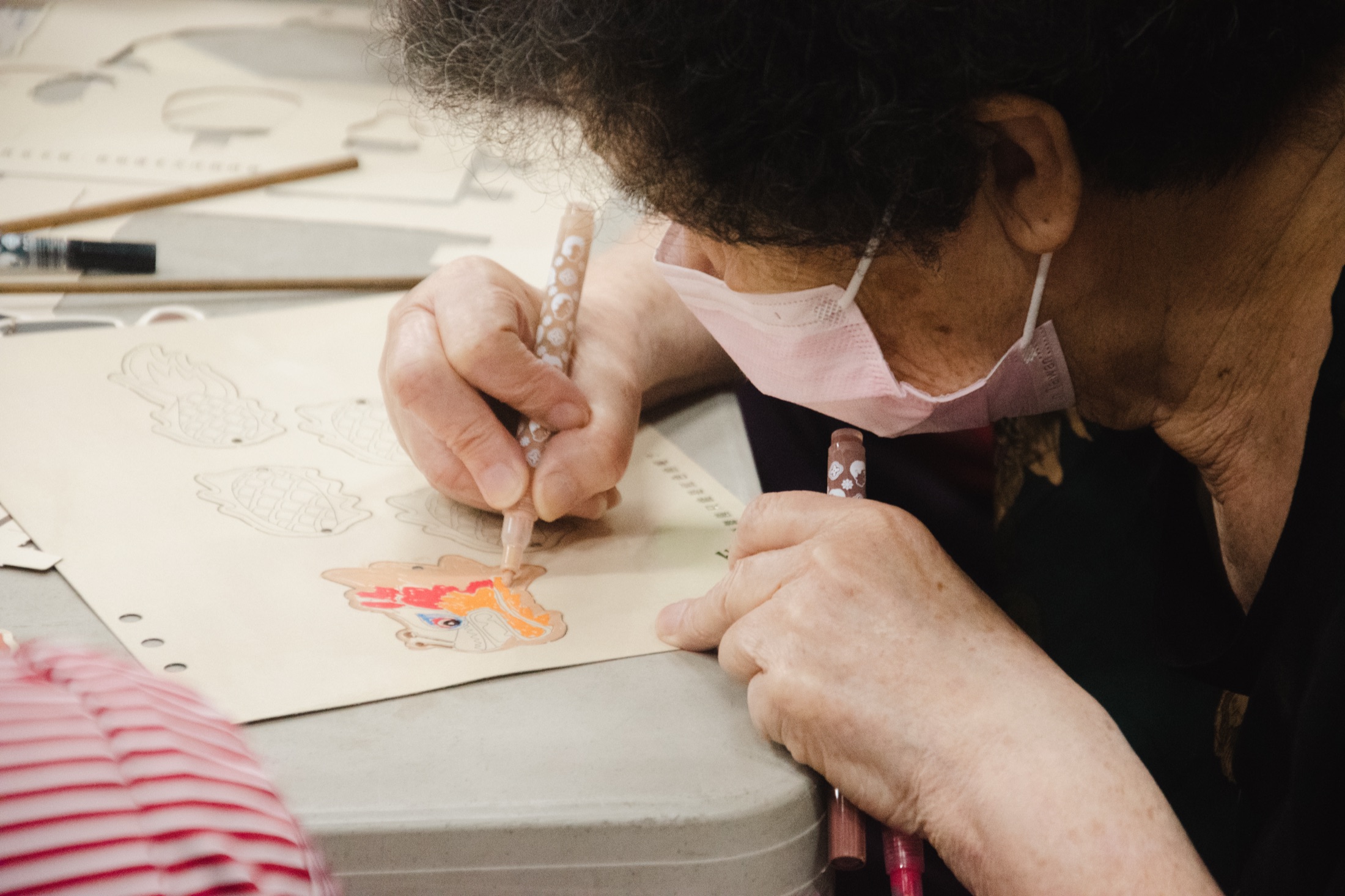 Process — participant hand-coloring puppet character during workshop